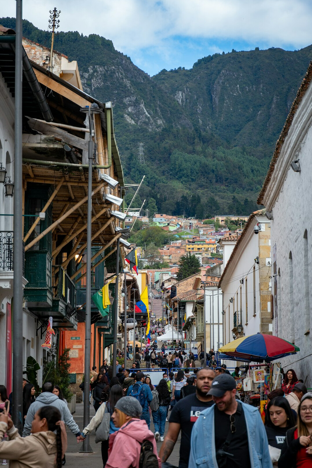 Colorful street in Valparaiso Chile with people walking in warm light
